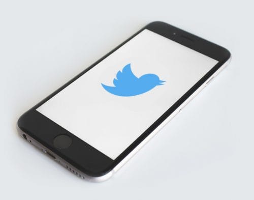 smartphone showing twitter logo smartphone showing twitter logo